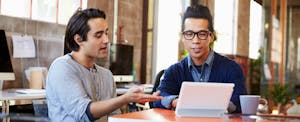 Two friends in an office arguing over what a 0 percent APR offer means