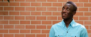 Young man standing in front of a brick wall and wondering, "What does it mean if I have a thin file?"