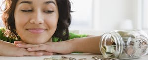 Woman looking at her savings, hoping to shave off some of her debt in the new year with Credit Karma's 30-day debt loss challenge