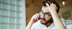 Anxious young man on smartphone