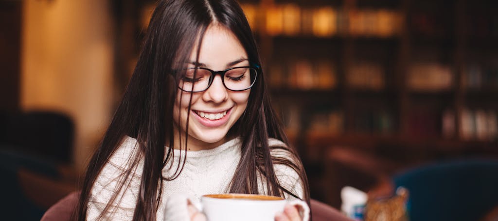 Young woman relaxes with a cup of coffee.