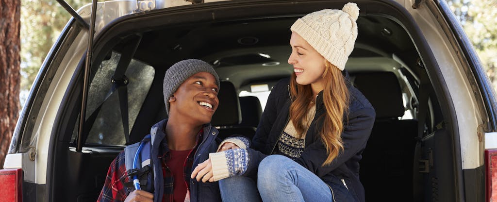 Couple in the open back of car looking at each other
