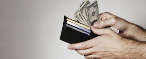 Hands with wallet and cash