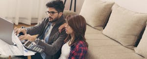 Young couple doing their paperwork together, paying bills online