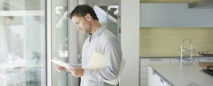Man looking through mail and papers at home