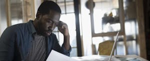 Focused businessman reviewing paperwork in office