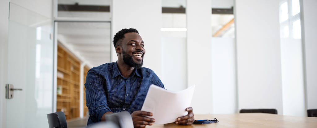 Man sitting in his office, smiling during a meeting