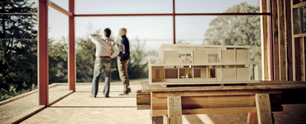 two men standing at a construction site
